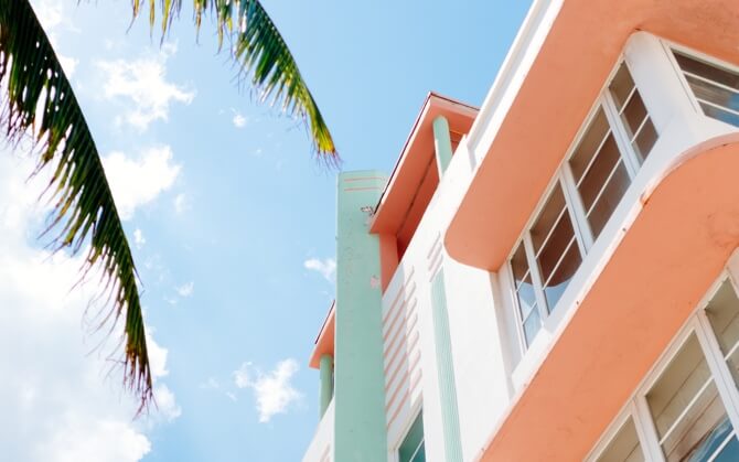 View of a beach house from the ground, looking upwards towards a blue sky.